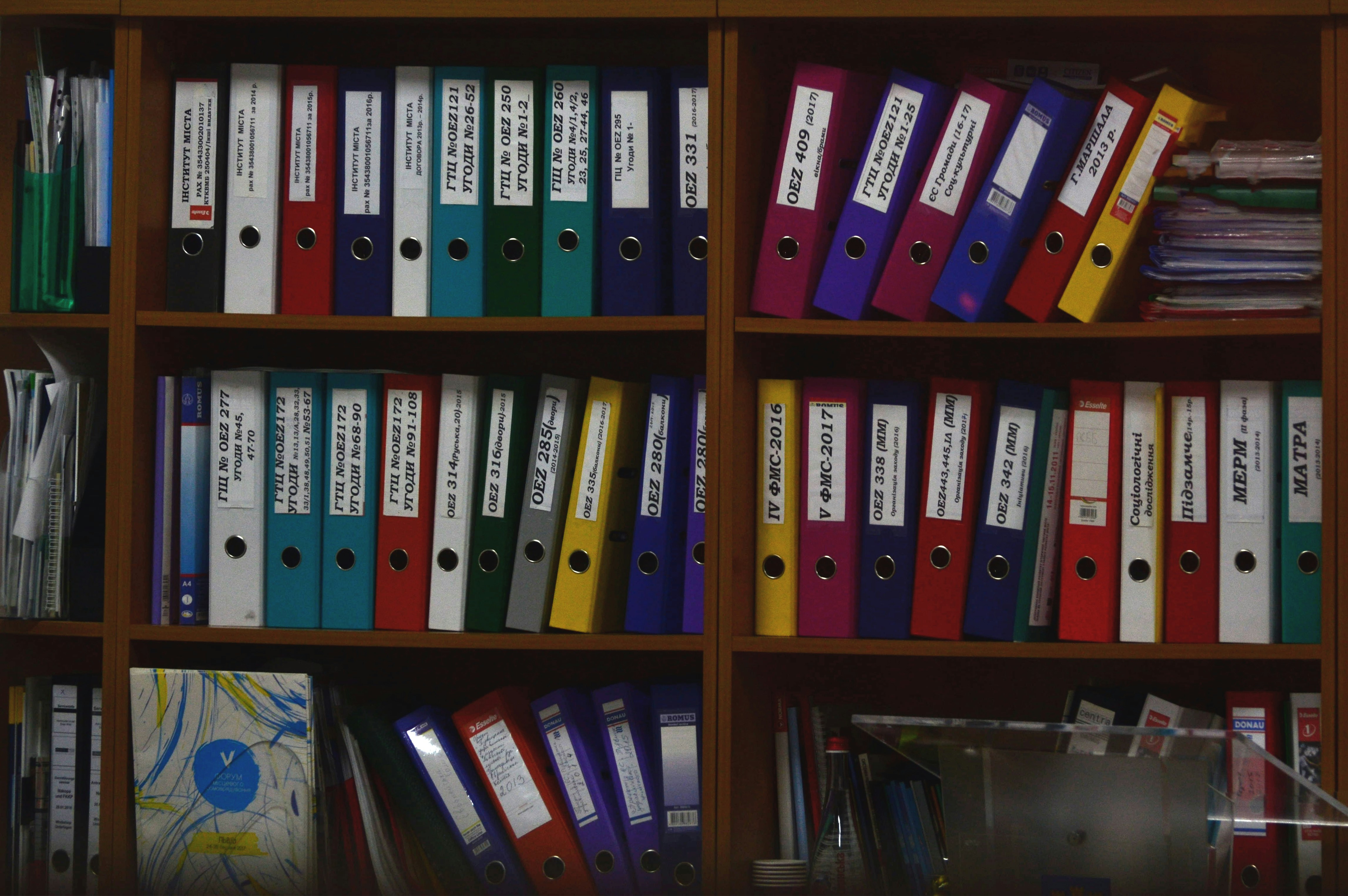 a cabinet with multicoloured files